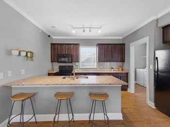 Kitchen with counter and barstool